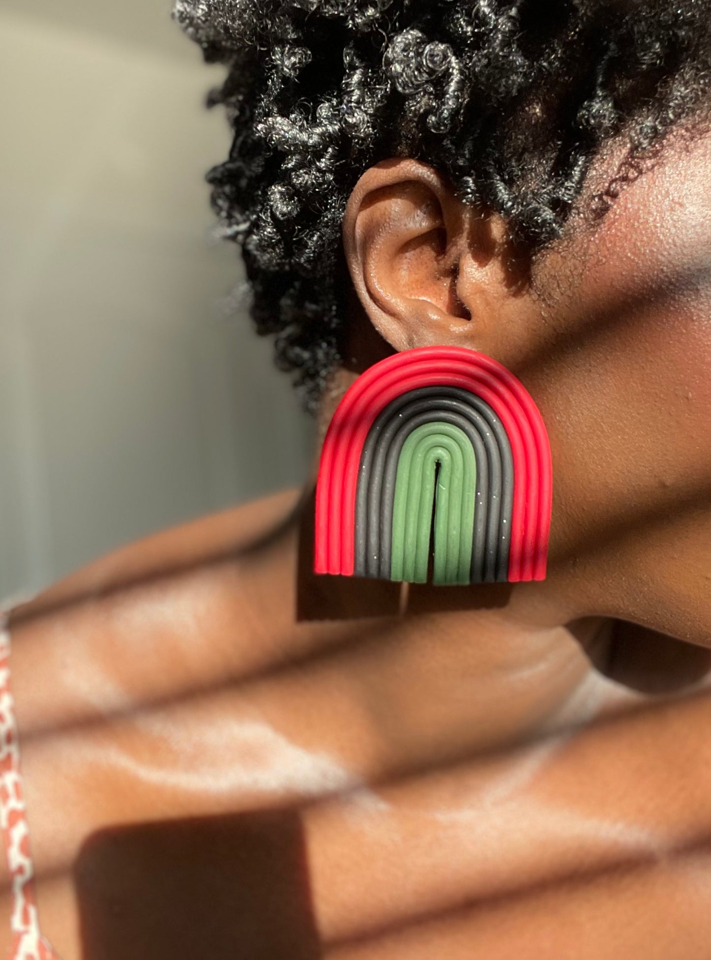 B.Lauren Designs Arch For The Culture Maximalist Studs with red, black, and green.