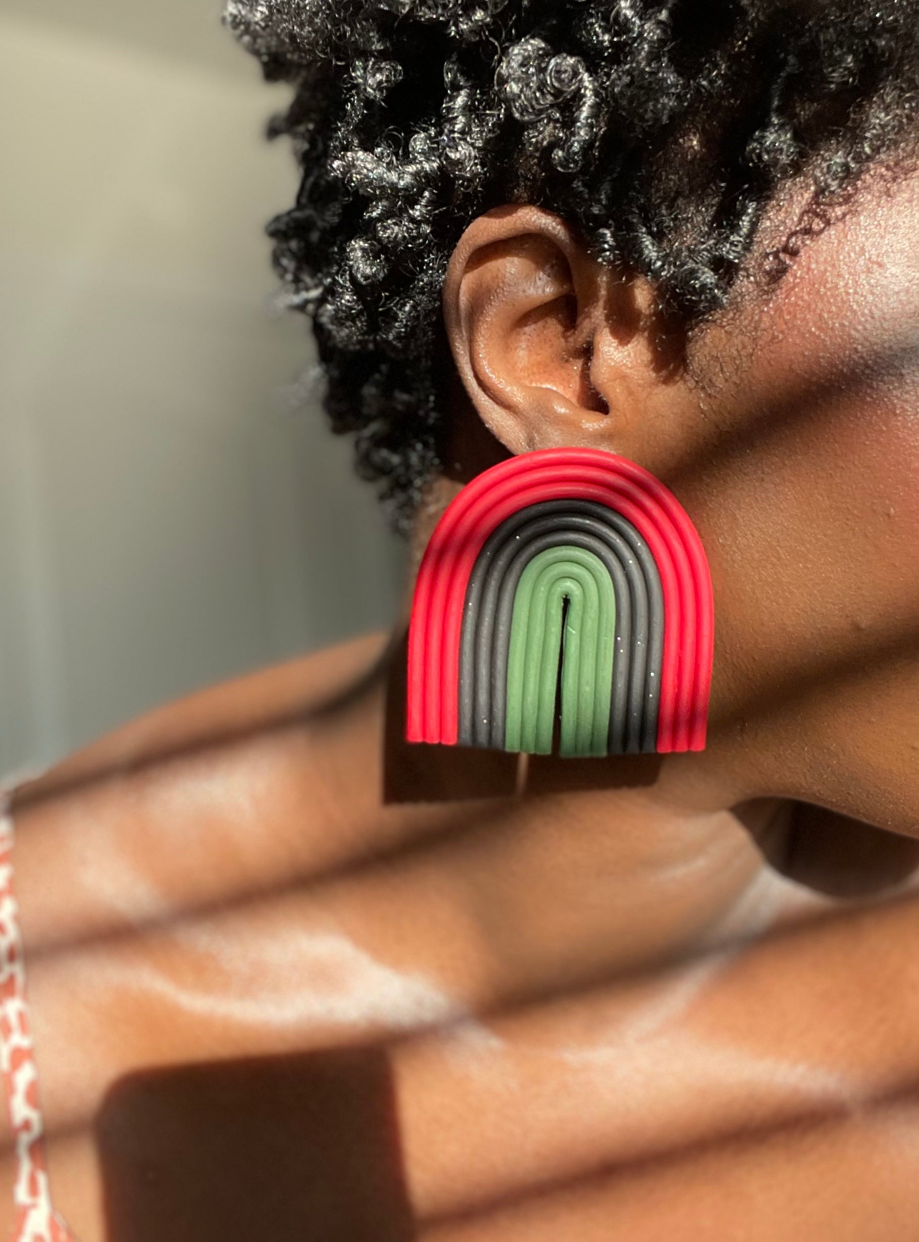B.Lauren Designs Arch For The Culture Maximalist Studs with red, black, and green.